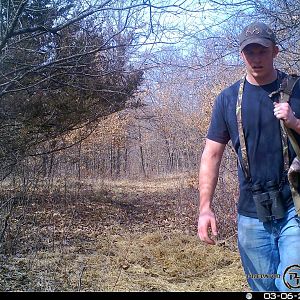Trail camera picture with shed on the ground. By my arm.