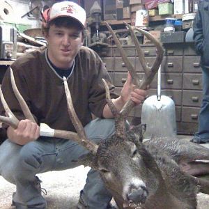 me and deer in shed before hangin him up